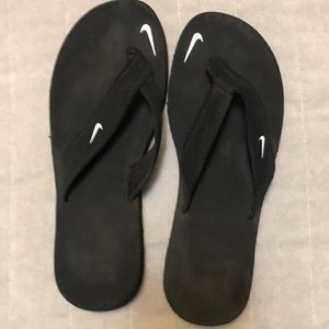Black Nike flip flops size 7.